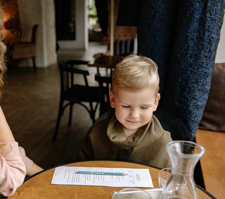 Young child sitting at a family-friendly restaurant in Tromsø